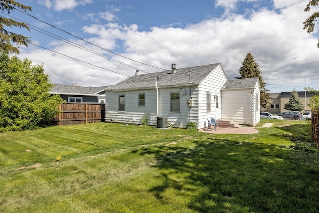 925 Hollins Ave, Helena, MT 59601 - back of property featuring central AC unit, a patio area, and roof with shingles