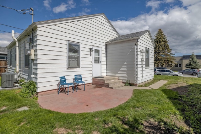 925 Hollins Ave, Helena, MT 59601 - rear view of house featuring a lawn, central air condition unit, and a patio area