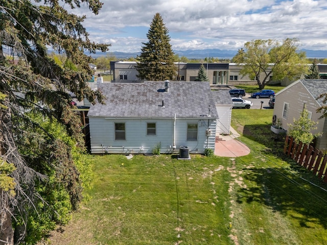 925 Hollins Ave, Helena, MT 59601 - back of house featuring central air condition unit, a patio area, and a shingled roof