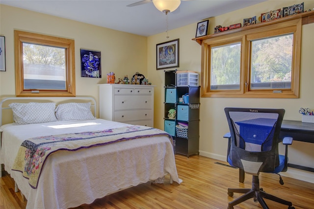 1320 Flowerree St, Helena, MT 59601 - bedroom featuring light wood-type flooring, multiple windows, baseboards, and a ceiling fan