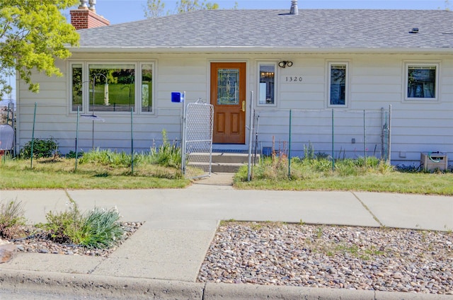 1320 Flowerree St, Helena, MT 59601 - view of front of home with a shingled roof and a chimney