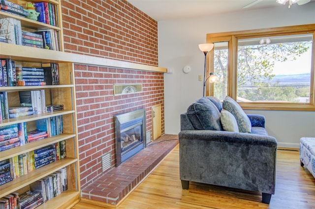 1320 Flowerree St, Helena, MT 59601 - living area featuring wood finished floors, a fireplace, and ceiling fan