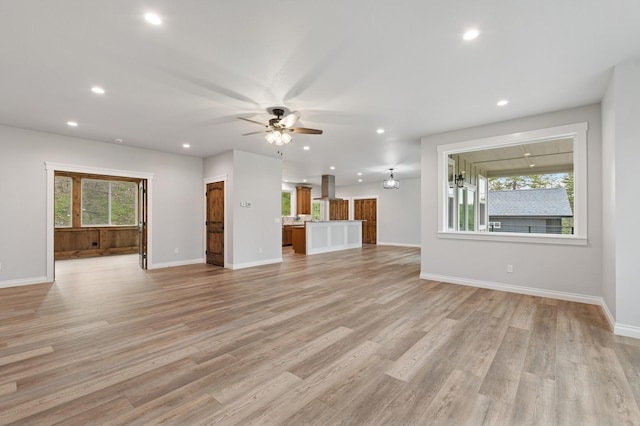 323 Skookum Rd, Lakeside, MT 59922 - unfurnished living room featuring recessed lighting, a ceiling fan, baseboards, and light wood finished floors