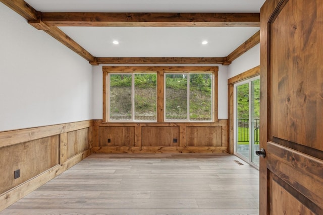 323 Skookum Rd, Lakeside, MT 59922 - spare room with plenty of natural light, light wood-style flooring, wainscoting, wood walls, and recessed lighting