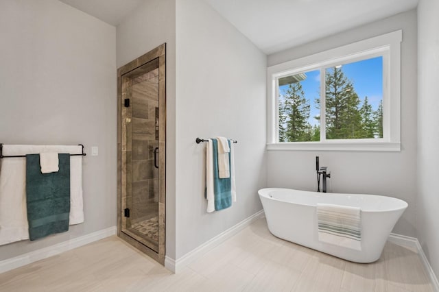 323 Skookum Rd, Lakeside, MT 59922 - bathroom with a freestanding tub, a stall shower, and baseboards