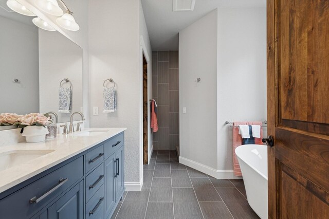 323 Skookum Rd, Lakeside, MT 59922 - full bath with double vanity, a freestanding tub, and baseboards
