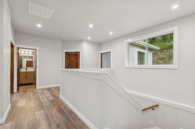 323 Skookum Rd, Lakeside, MT 59922 - corridor with an upstairs landing, light wood-type flooring, recessed lighting, and baseboards