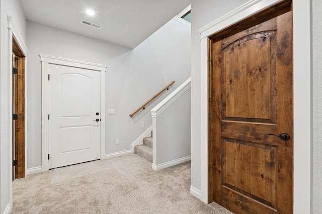 323 Skookum Rd, Lakeside, MT 59922 - foyer entrance featuring carpet floors, stairs, and baseboards