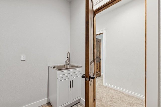 323 Skookum Rd, Lakeside, MT 59922 - hallway featuring a sink, light carpet, and baseboards