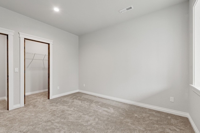 323 Skookum Rd, Lakeside, MT 59922 - unfurnished bedroom featuring carpet, a walk in closet, baseboards, a closet, and recessed lighting