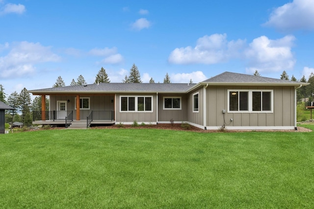323 Skookum Rd, Lakeside, MT 59922 - rear view of house featuring a lawn, covered porch, and board and batten siding