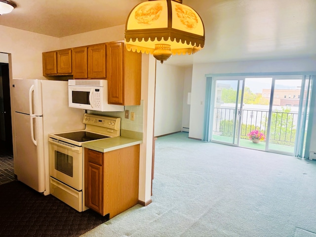 951 Ronald Ave Unit 410, Missoula, MT 59801 - kitchen featuring white appliances, carpet flooring, and brown cabinetry