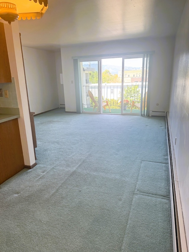 951 Ronald Ave Unit 410, Missoula, MT 59801 - unfurnished living room with baseboard heating, carpet, and plenty of natural light