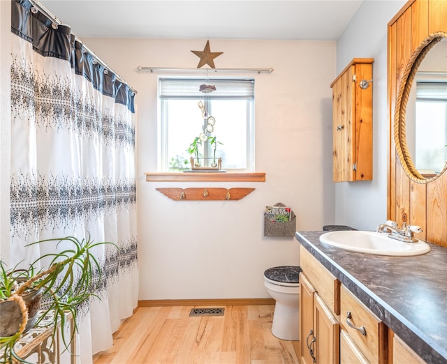 158 Parkside Dr, Kalispell, MT 59901 - bathroom with vanity, wood finished floors, toilet, and baseboards
