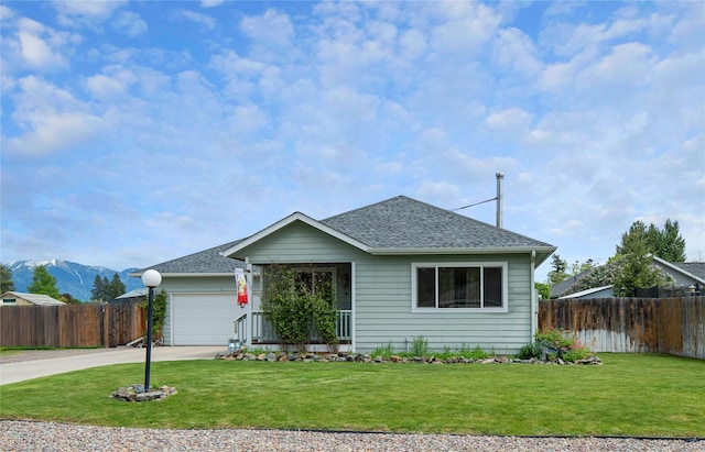 158 Parkside Dr, Kalispell, MT 59901 - view of front of property featuring driveway, roof with shingles, an attached garage, and a mountain view