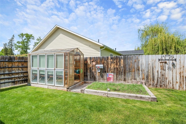 158 Parkside Dr, Kalispell, MT 59901 - back of property featuring a greenhouse and an outbuilding