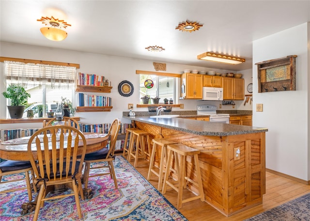 158 Parkside Dr, Kalispell, MT 59901 - dining space with plenty of natural light, light wood-style floors, and baseboards