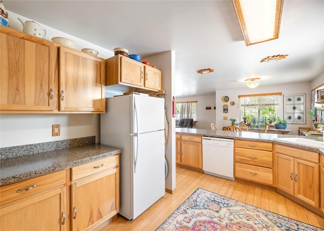 158 Parkside Dr, Kalispell, MT 59901 - kitchen featuring white appliances, light wood-type flooring, a sink, and light brown cabinets