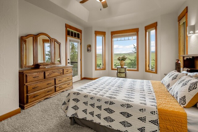 36665 Highland Ct, Polson, MT 59860 - bedroom with access to exterior, light carpet, baseboards, and ceiling fan