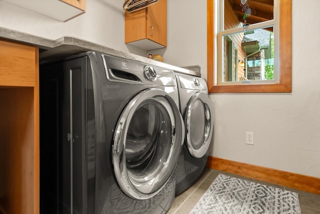 36665 Highland Ct, Polson, MT 59860 - laundry room featuring cabinet space, washer and dryer, and light tile patterned floors