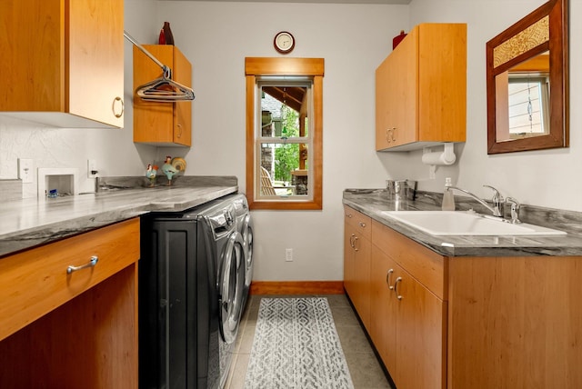 36665 Highland Ct, Polson, MT 59860 - laundry room with cabinet space, washing machine and clothes dryer, light tile patterned floors, and baseboards