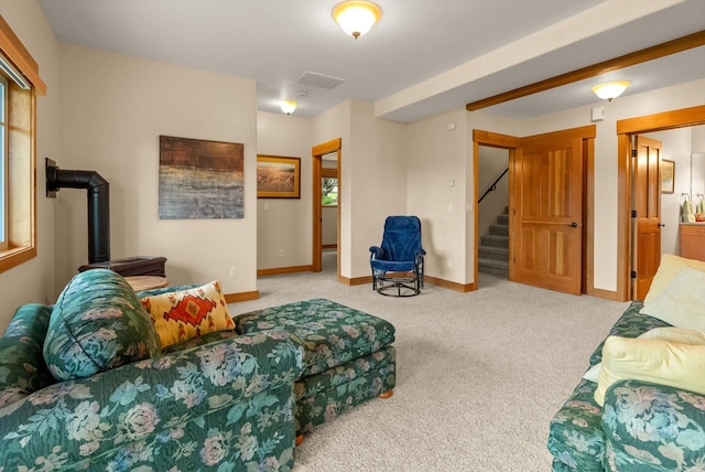 36665 Highland Ct, Polson, MT 59860 - carpeted living room with stairs, a wood stove, and baseboards