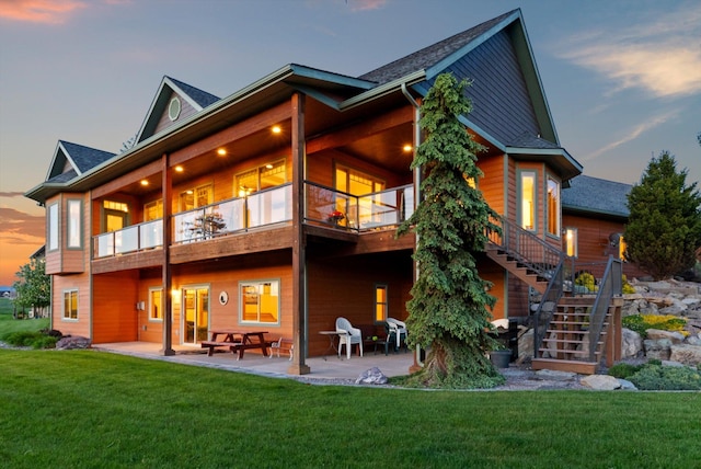 36665 Highland Ct, Polson, MT 59860 - rear view of property featuring a patio area, a yard, stairway, and a balcony