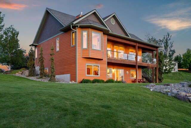 36665 Highland Ct, Polson, MT 59860 - back of property at dusk with a lawn and stairs