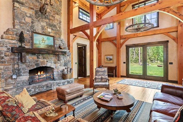 380 Haskill Basin Rd, Whitefish, MT 59937 - living area with a stone fireplace, wood-type flooring, high vaulted ceiling, french doors, and beamed ceiling