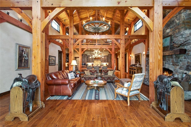 380 Haskill Basin Rd, Whitefish, MT 59937 - living room with a chandelier, wood finished floors, a fireplace, high vaulted ceiling, and beam ceiling