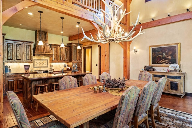 380 Haskill Basin Rd, Whitefish, MT 59937 - dining area featuring dark wood finished floors, a chandelier, arched walkways, and recessed lighting