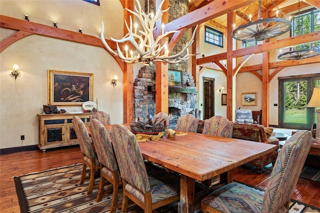 380 Haskill Basin Rd, Whitefish, MT 59937 - dining area with a chandelier, high vaulted ceiling, hardwood / wood-style floors, arched walkways, and beam ceiling