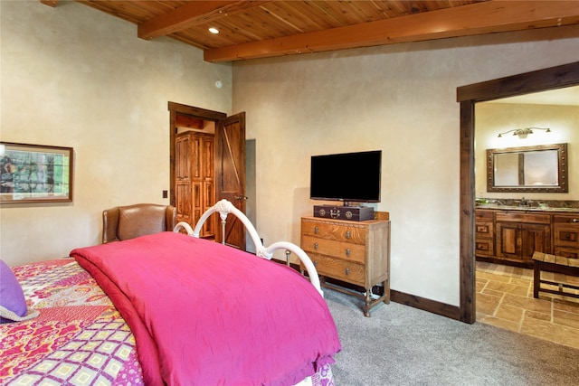 380 Haskill Basin Rd, Whitefish, MT 59937 - carpeted bedroom featuring a wood ceiling with exposed beams and ensuite bathroom