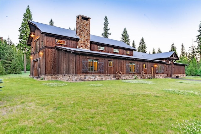380 Haskill Basin Rd, Whitefish, MT 59937 - back of property featuring a chimney and a yard