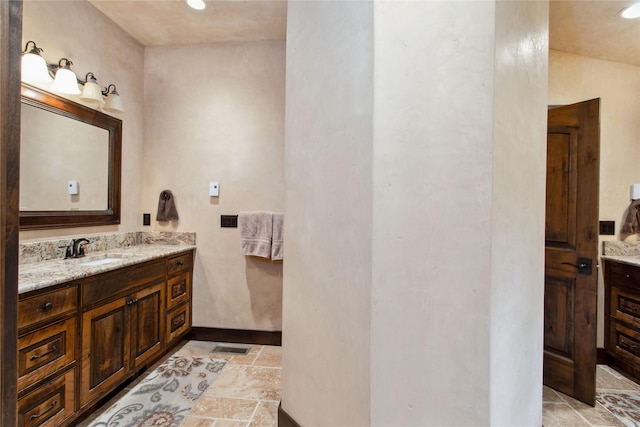380 Haskill Basin Rd, Whitefish, MT 59937 - bathroom with vanity, stone tile floors, and recessed lighting