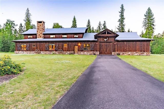 380 Haskill Basin Rd, Whitefish, MT 59937 - view of front of house with a chimney and a front lawn
