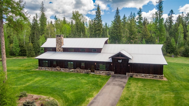 380 Haskill Basin Rd, Whitefish, MT 59937 - view of front of home featuring a front lawn, a chimney, and a wooded view