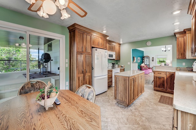 1502 Hauser Blvd, Helena, MT 59601 - kitchen with white appliances, healthy amount of natural light, a kitchen island, light countertops, and recessed lighting