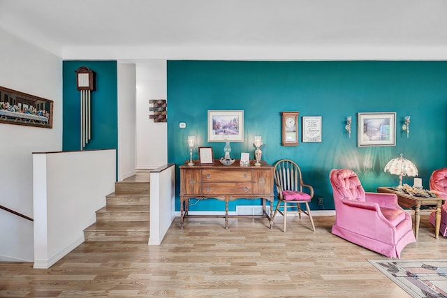 1502 Hauser Blvd, Helena, MT 59601 - sitting room featuring wood finished floors, baseboards, and an accent wall