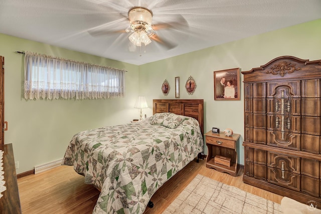 1502 Hauser Blvd, Helena, MT 59601 - bedroom featuring baseboards, a baseboard heating unit, wood finished floors, and a ceiling fan