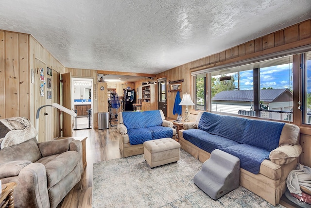 1502 Hauser Blvd, Helena, MT 59601 - living area with wood finished floors, wood walls, and a textured ceiling