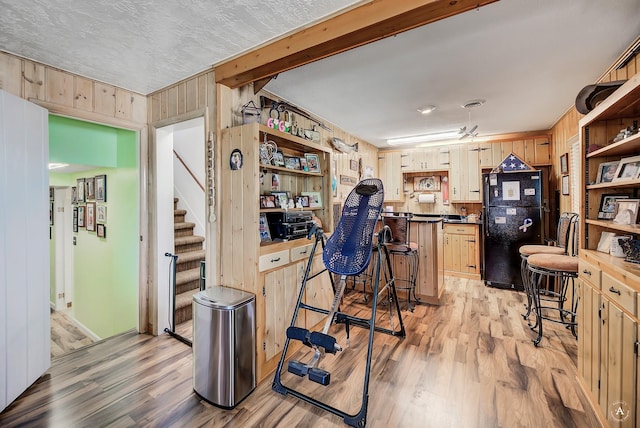 1502 Hauser Blvd, Helena, MT 59601 - kitchen with freestanding refrigerator, light wood-type flooring, open shelves, dark countertops, and light brown cabinetry