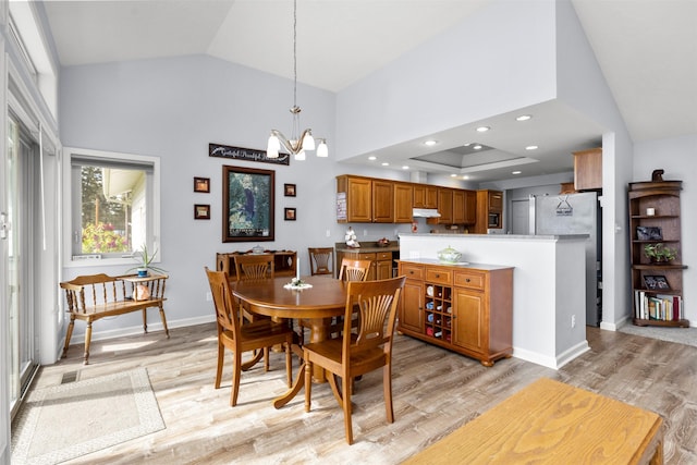 100 Rimini Rd, Lakeside, MT 59922 - dining space featuring a chandelier, light wood finished floors, baseboards, and high vaulted ceiling