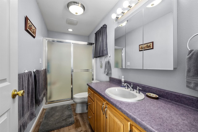 100 Rimini Rd, Lakeside, MT 59922 - bathroom with toilet, vanity, wood finished floors, and a stall shower