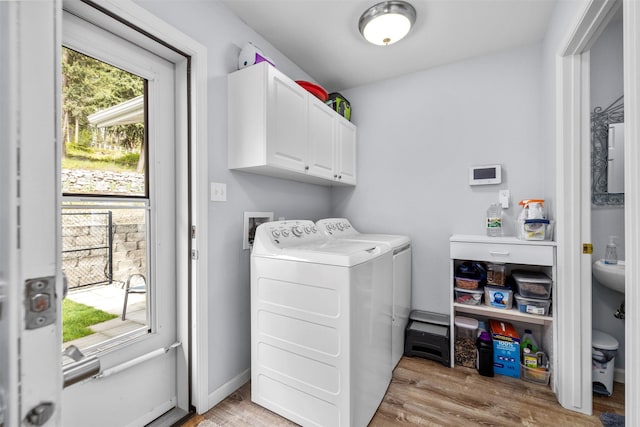 100 Rimini Rd, Lakeside, MT 59922 - washroom with cabinet space, separate washer and dryer, and light wood-style flooring