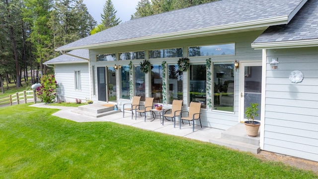 100 Rimini Rd, Lakeside, MT 59922 - back of property with a shingled roof and a patio area