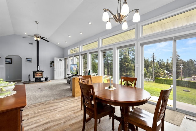 100 Rimini Rd, Lakeside, MT 59922 - dining area with a wood stove, light wood-style flooring, plenty of natural light, ceiling fan, and recessed lighting