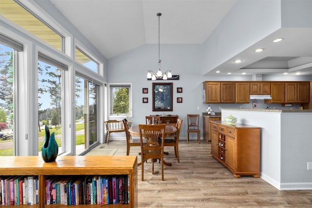 100 Rimini Rd, Lakeside, MT 59922 - dining room with a chandelier, light wood-style flooring, recessed lighting, baseboards, and high vaulted ceiling
