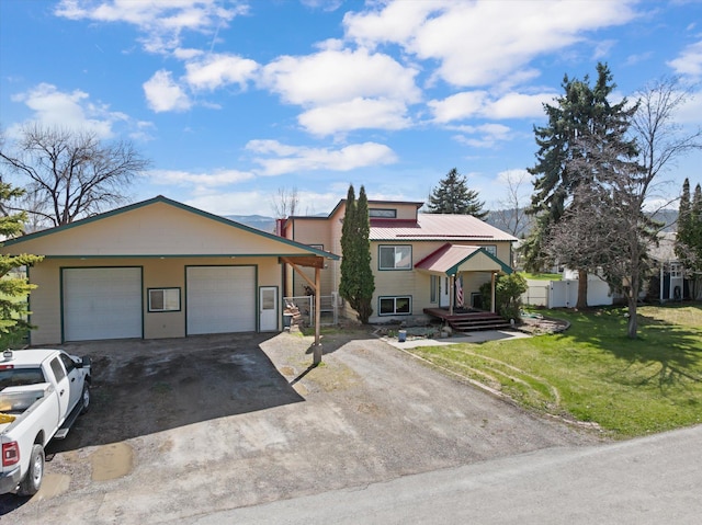 1509 Eagle Dr, Kalispell, MT 59901 - view of front of home with metal roof, driveway, and a detached garage
