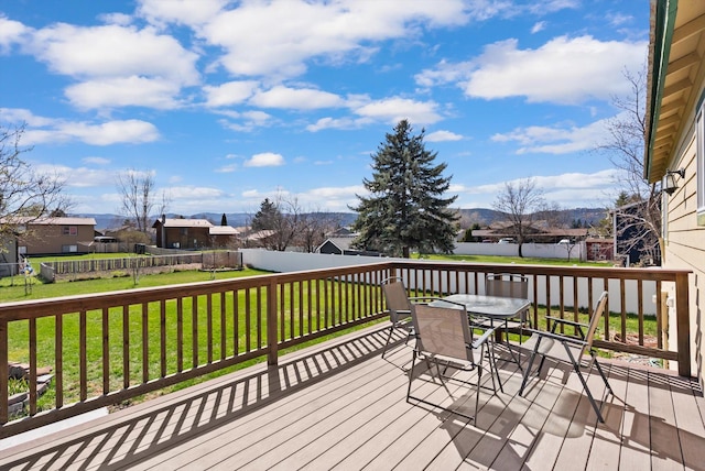 1509 Eagle Dr, Kalispell, MT 59901 - wooden terrace featuring outdoor dining space, a residential view, and a mountain view